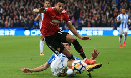 Huddersfield Town’s Christopher Schindler tackles Jesse Lingard on Saturday.