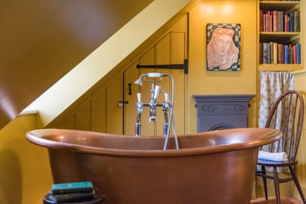 Fancy copper tub in a yellow bathroom