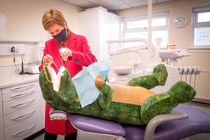 Nicola Sturgeon checks the teeth of huge stuffed dinosaur