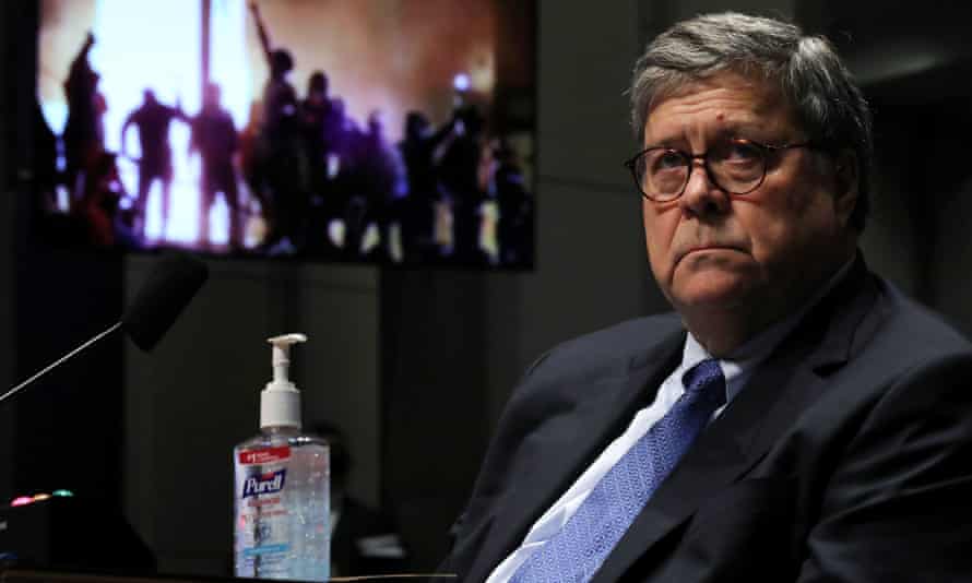 Barr watches a Republican Exhibit video of people rioting during a the House hearing in July 2020.