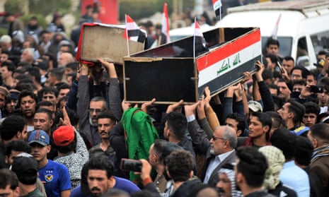 People carry the coffins of anti-government demonstrators killed during protests on Thursday in the central holy shrine city of Najaf, Iraq.