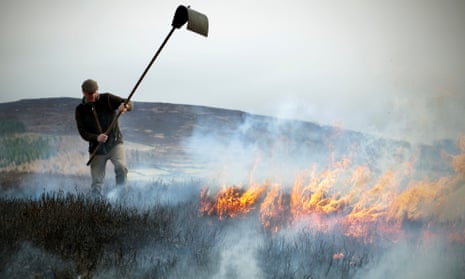 Tom Adamson, Gamekeeper for the Bolton Abbey Estate uses a Batter to smother the flames during Moorland Burning on Barden Moor in the Yorkshire Dales. April 2021