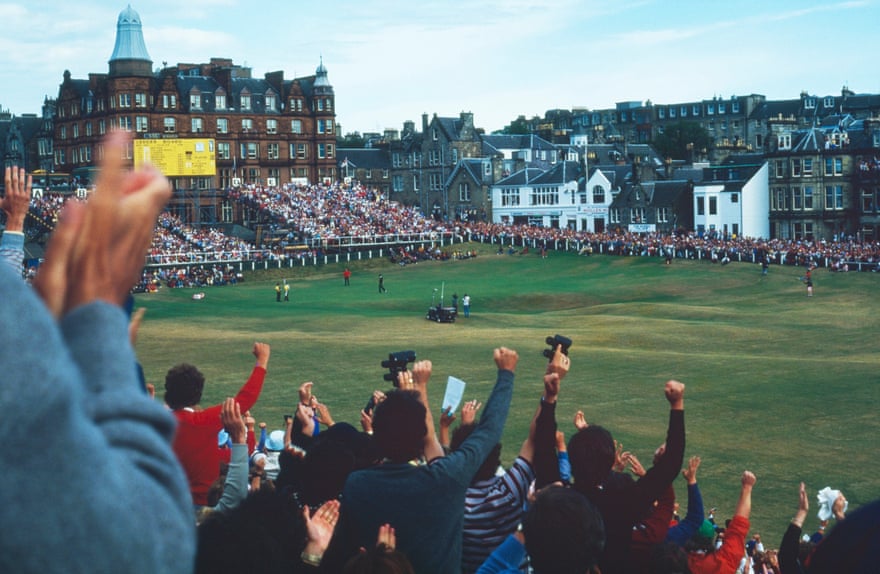 The St Andrews crowds cheer as Seve Ballesteros celebrates.