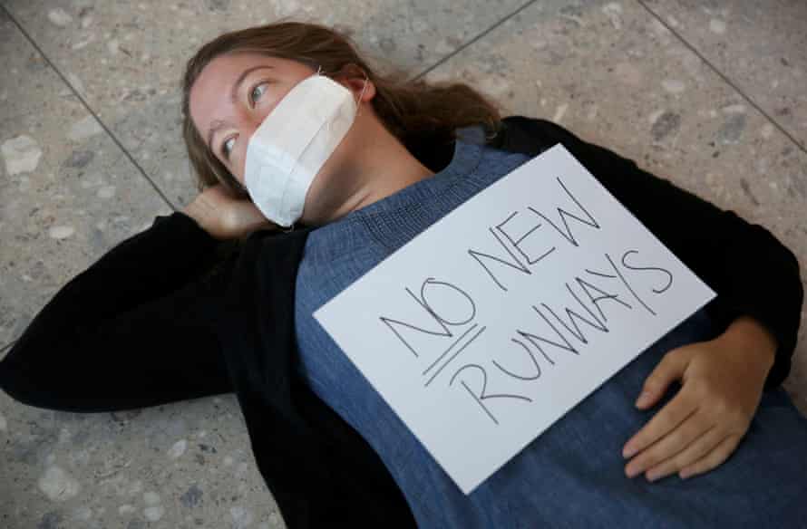 A climate activist from the group Reclaim the Power lies on the ground during a protest against airport expansion plans at Heathrow.