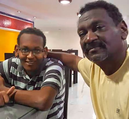 A father with his arm around his son’s shoulders