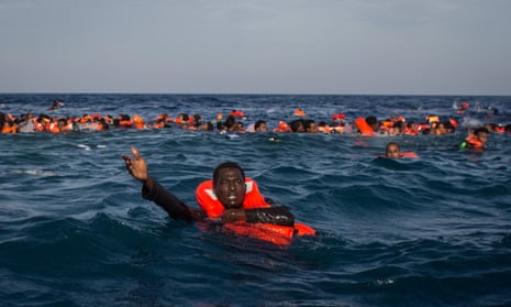Refugees shout for help after a boat capsized off Italy last year.