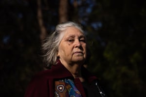 Delia Lowe, an Jerringa Aboriginal elder looks into the camera. Her face and grey hair are illuminated but her surroundings are dark