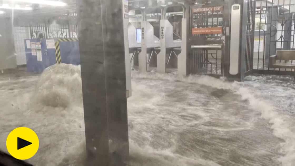 Footage shows flood water gushing into New York subway station during heavy rain – video