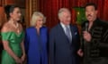 King Charles and Queen Camilla wander into shot between Katy Perry and Lionel Richie as they speak on a live stream from Windsor