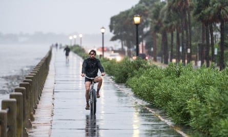 A man rides a bicycle along the Charleston battery a day before Hurricane Dorian’s arrival.