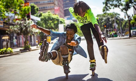 Nelson Mbusyei and Angela Martha practise a move known as the footgun on a downtown street.