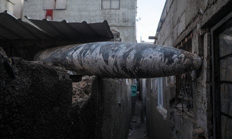 An unexploded Israeli missile stuck between two houses of Al Nusairat refugee camp, central Gaza on Wednesday.