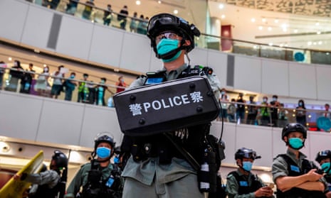 A riot police officer stands guard during a clearance operation at a demonstration in a mall in Hong Kong 