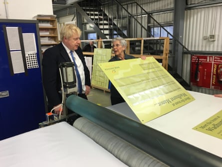 Jane Kelvey shows Boris Johnson a sign making process in her then workplace