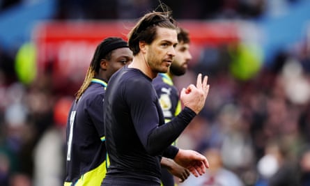 Jack Grealish holds up three fingers, symbolising the three Premier League titles he has won