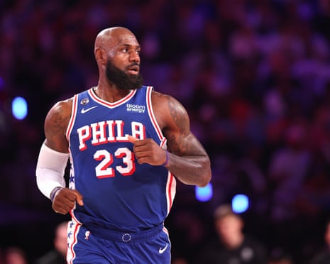 LeBron James jogs on court in a Philadelphia 76ers jersey, looking to the side