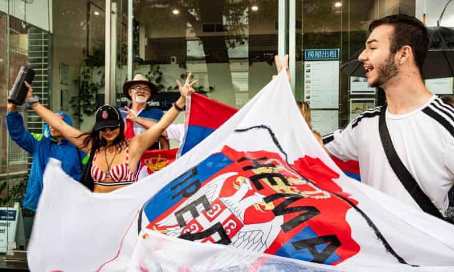 Supporters gather outside Park Hotel in Melbourne where Novak Djokovic was taken