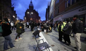 Mourners write messages next to a makeshift altar in Nottingham.
