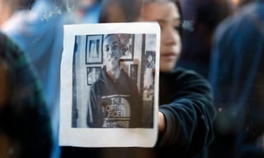 A child holds up a picture of Stephon Clark during a protest.