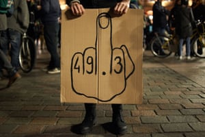 A woman holds a placard reading ‘49.3’ in Toulouse, after Borne’s use of article 49.3 to pass Macron’s pension changes