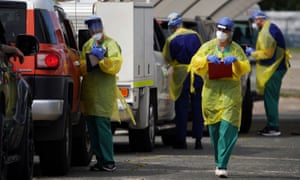 Medical personnel administer tests for coronavirus at the Bondi Beach drive-through testing centre in Sydney.