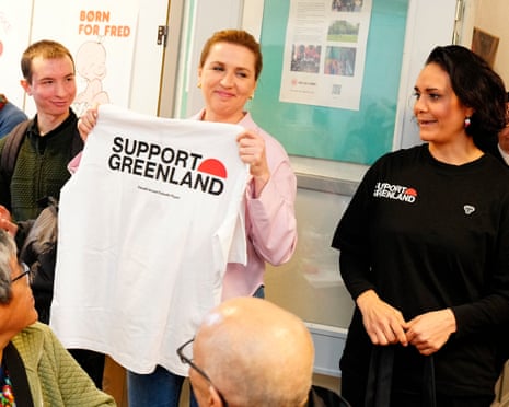 Denmark's prime minister and Social Democrats' leader Mette Frederiksen holds up a "Support Greenland" shirt as she meets Greenlandic voters on election day, in Aalborg, Denmark.