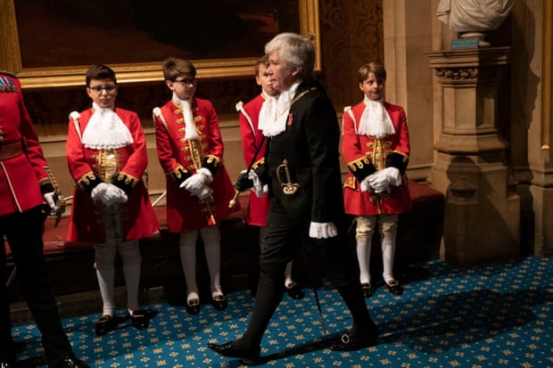 Lady Usher of the Black Rod, Sarah Clarke, walks past page boys for the state opening of parliament.