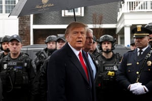 Donald Trump speaks while armed police officers stand behind him