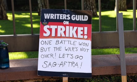 A WGA support sign rests near Sag-Aftra members picketing outside Warner Bros Studio as the actors’ strike continues in Burbank, California, last month.