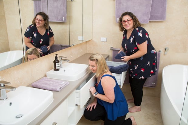 Bathrooms also need to be organized. Amy and Christy of The Art of Decluttering at work.