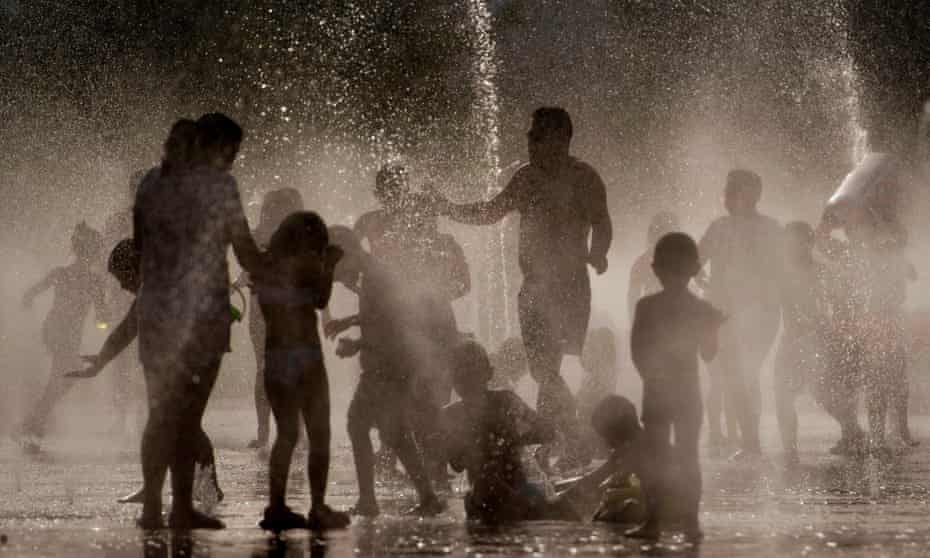 People cool off in a fountain in Madrid.