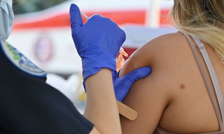 FILES-US-HEALTH-VIRUS-VACCINE-POLITICS-MANDATE<br>(FILES) In this file photo taken on August 23, 2021, a Los Angeles County emergency medical technician administers a second dose of Pfizer-BioNTech Covid-19 vaccine at a pop up vaccine clinic in the Arleta neighborhood of Los Angeles. - Strict rules intended to push tens of millions of US workers into getting vaccinated against Covid-19 will come into effect on January 4, 2022, President Joe Biden's administration announced November 4, 2021. The mandates targeting businesses with more than 100 employees, health care workers, and federal contractors represent the most aggressive steps Washington has taken yet against the virus and its Delta variant. (Photo by Robyn Beck / AFP) (Photo by ROBYN BECK/AFP via Getty Images)