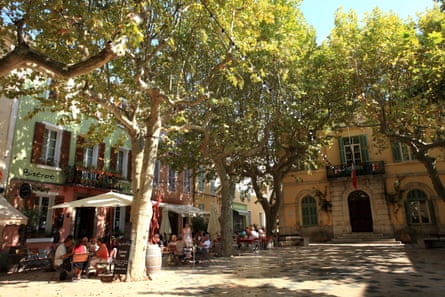 People dining in a square in the village of Collobrières