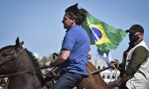 Brazil’s President Jair Bolsonaro rides a horse greeting supporters outside the presidential palace in Brasilia on Sunday.