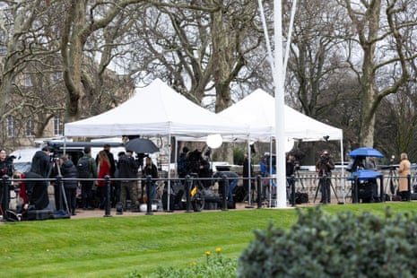 Reporters stood outside Buckingham Palace.