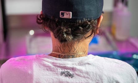 A closeup of Cake’s tattooed neck