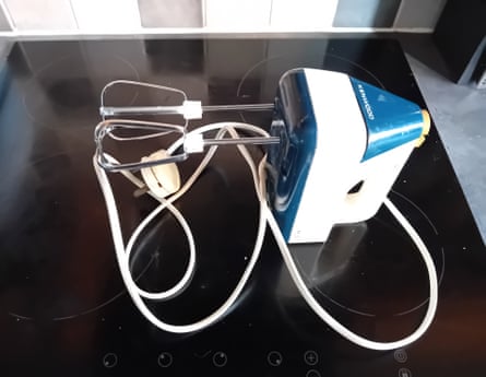 A blue and white food mixer with two beaters inserted