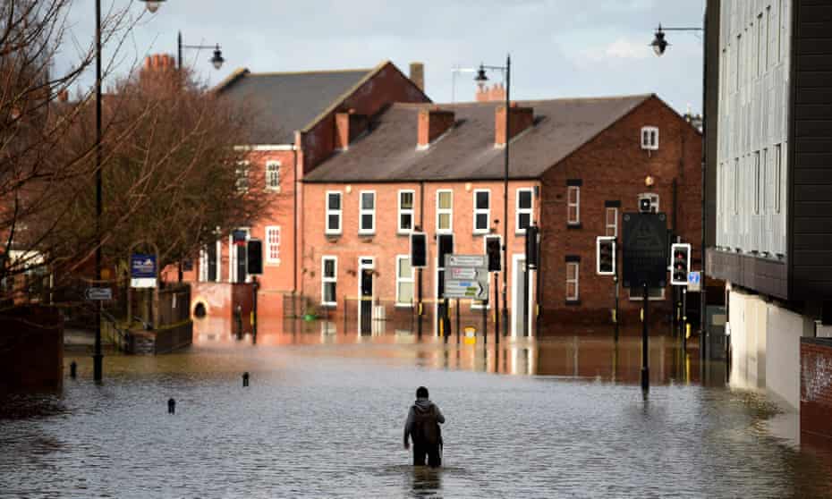 A man wades through flood waters in Shrewsbury.