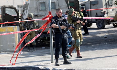 Israeli soldiers stand guard at the scene where a Palestinian allegedly carrying a knife was shot dead by Israeli soldiers in the West Bank city of Hebron.