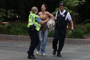Police officers detain a woman