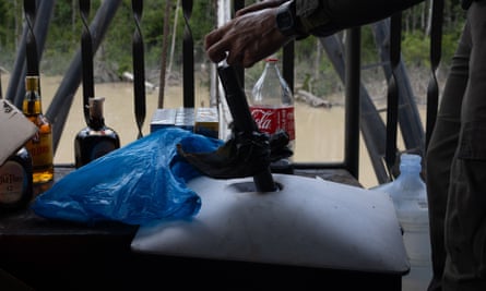 A Brazilian ranger places his hand on a Starlink antenna
