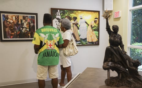 Visitors admire the artwork displayed in the Beacon of Hope exhibition at the Woodson African American Museum of Florida, in honor of Juneteenth, on 19 June in St Petersburg, Florida.