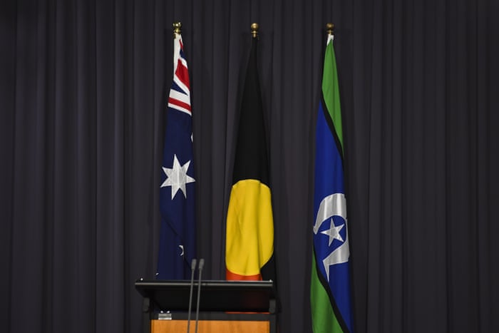 Bandeiras australianas, aborígenes e de Torres Strait Islander atrás de um púlpito