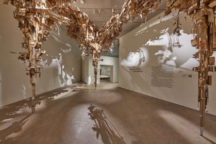 Art installation of cardboard shaped like an upside down skyline in a gallery