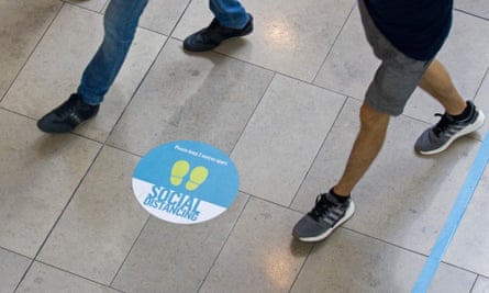 Social distancing signs on the floor in Westfield shopping centre in Stratford, east London