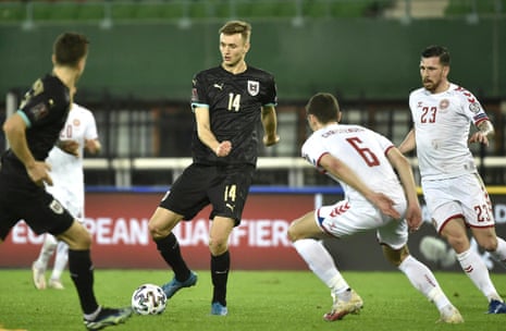 Austria’s forward Sasa Kalajdzic (C) passes the ball.