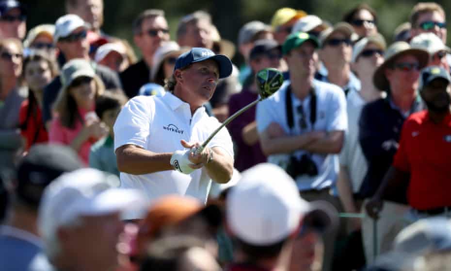 Swinging back and forth: Phil Mickelson plays a shot from the 8th during a wildly inconsistent performance at Augusta National yesterday.