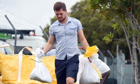 Brisbane man carrying sandbags