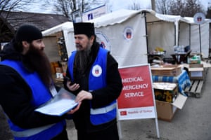 Romanian Orthodox Monks, Father Sofian and Father Dosoftei, discuss logistics at their hospitality tent in Siret, Romania, 13 March