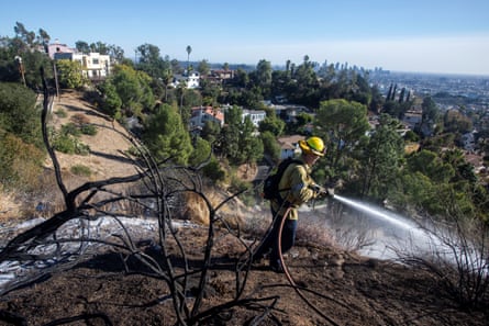 Firefighters work on hot spots after a brush fire burned in Griffith Park in Los Angeles, California, on 20 January 2025.